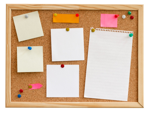 blank paper and post it notes pinned to  a horizontal noticeboard