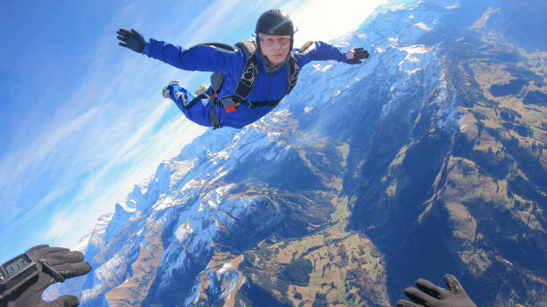 istock Skydivers fall through clear skies, aerial flight 1369376343