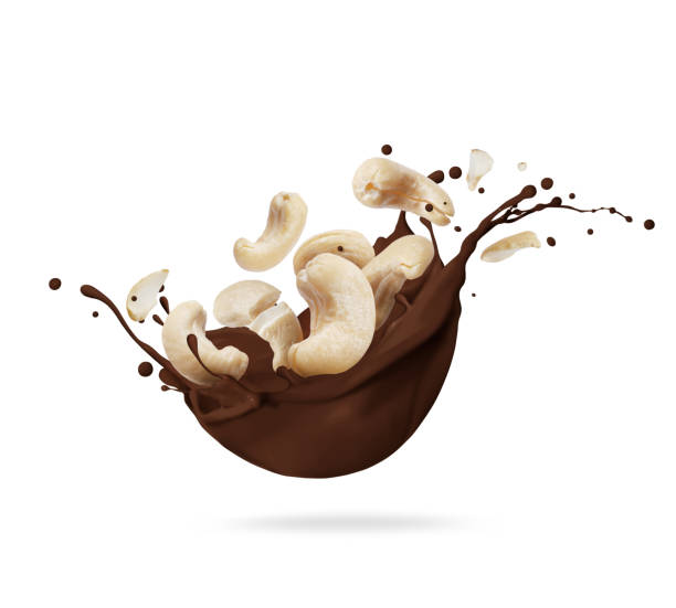 istock Dried crushed cashew nuts in chocolate splashes isolated on white background 1369376717