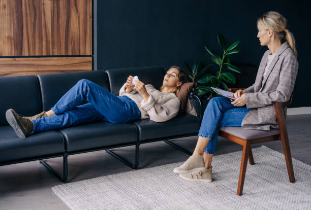 istock A woman lying on a couch talks about her trauma to a psychoanalyst. 1369377350