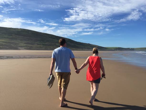 istock Couple walking hand in hand 1369377396