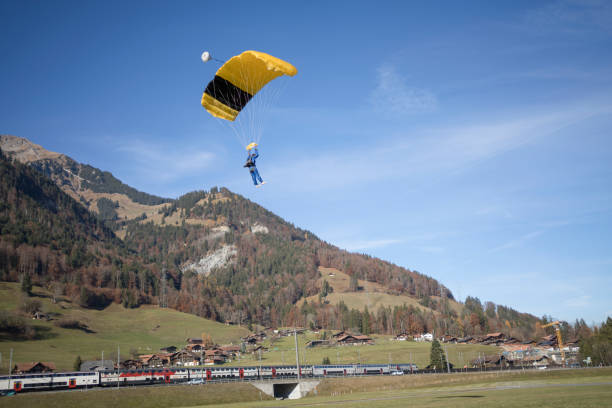istock Paraglider glides through clear skies, in aerial flight 1369377767