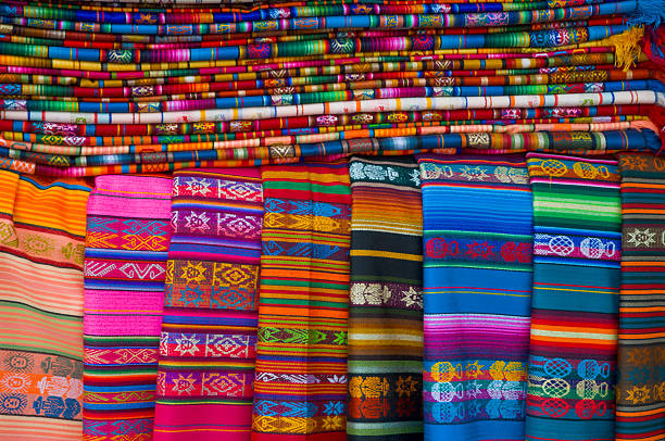 A stack of vibrant Navajo blankets for sale at a stand in Santa Fe, New Mexico