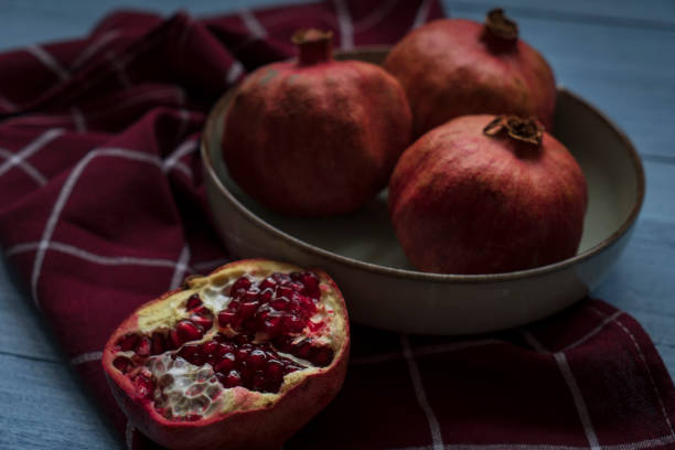 istock Ripe pomegranate fruit on wooden background 1369379357