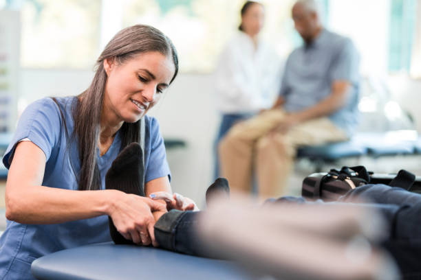istock Female therapist massages unrecognizable man's injured foot 1369379614