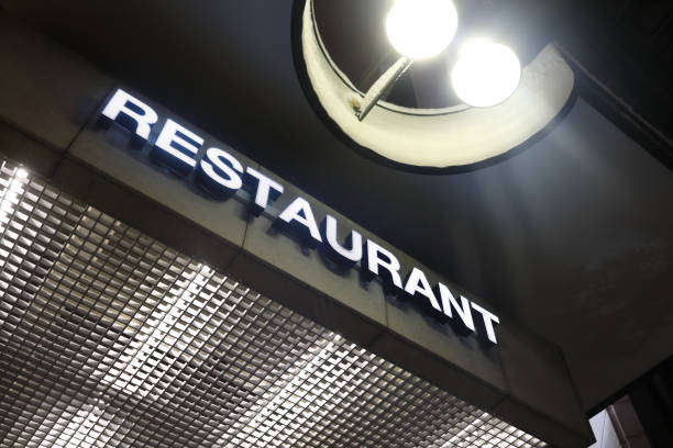 istock Glowing restaurant sign board at night 1369381057