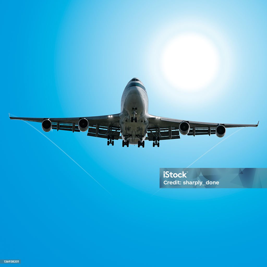 jumbo jet airplane landing in sunny sky jumbo jet airplane landing in bright sunny sky, square frame Above Stock Photo