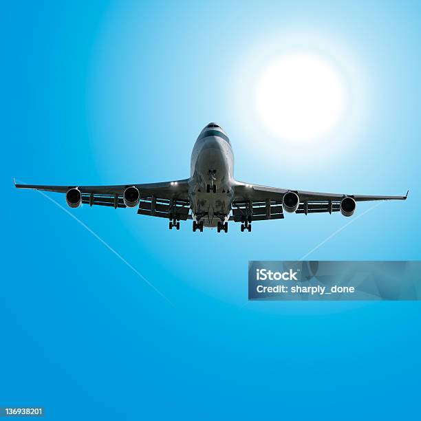 Jumbo Jet Airplane Landing In Sunny Sky Stock Photo - Download Image Now - Above, Aerospace Industry, Air Vehicle