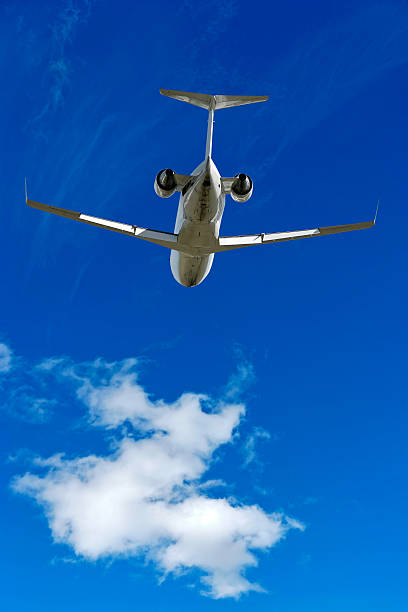 istock XXL corporate jet airplane flying in bright sky 136938332