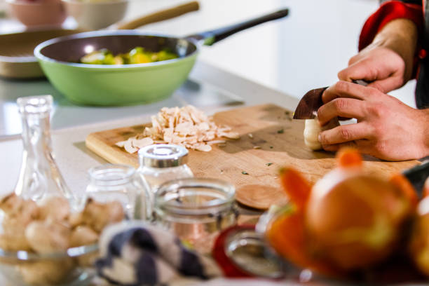 istock Copy space shot of chef chopping veggies and a garlic in half 1369384759