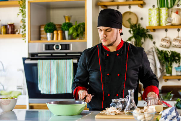 istock Chef holding a pan and spreading spices he added 1369384776