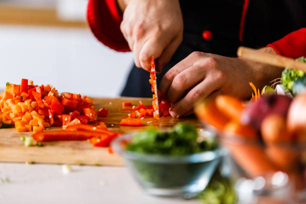 istock Selective focus shot of unrecognizable chef dicing a red bell pepper 1369385812