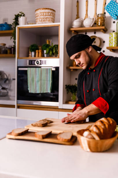 istock Professional chef preparing bread and buns for sandwiches 1369386073
