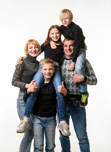 Portrait of happy family in new house. Mid adult parents, teenage girl and little boy together, looking at camera smiling. Real estate, purchase, family concept