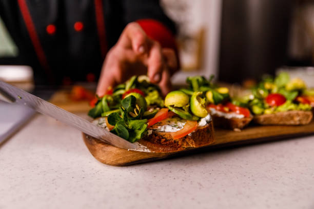 istock Chef serving vegan sandwiches on a wooden board 1369387127