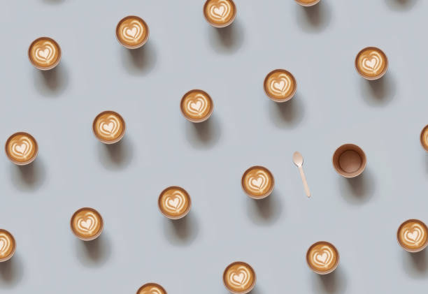 Repeating pattern of Eco-friendly disposable cup with heart shape latte coffee over gray background. Top view