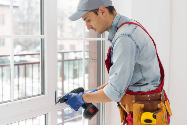 istock handsome young man installing bay window in a new house construction site. 1369388971