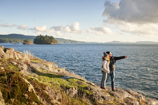 istock Couple looking at the view during a hike along a rocky coast 1369391305
