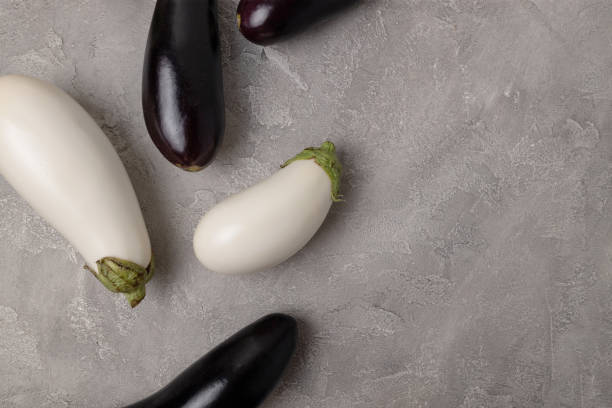 istock Assorted white and blue fresh raw eggplant pattern on gray on table background. Healthy vegetarian diet food 1369392433