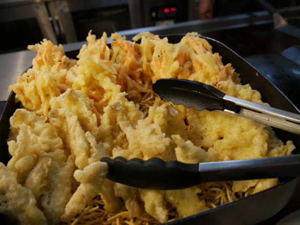 istock Breaded fried shrimp on a bed of fried noodles 1369393709