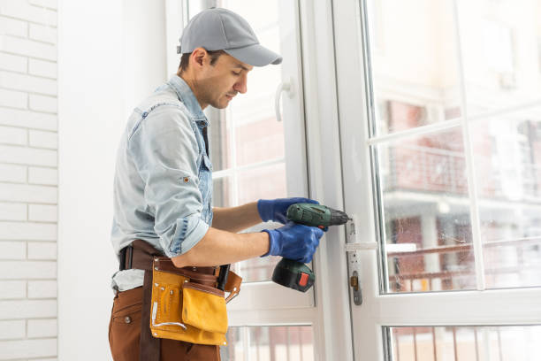 istock Man fixing lock to window with electric screwdriver 1369394013
