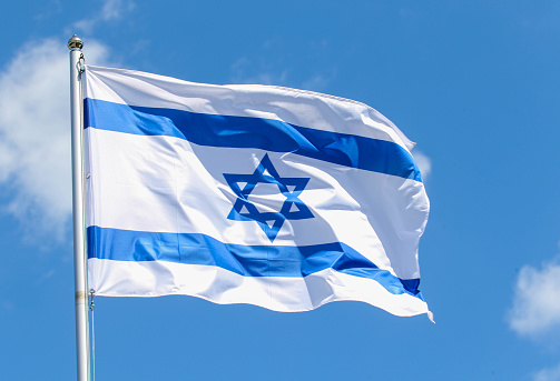 Israel flag on blue sky background