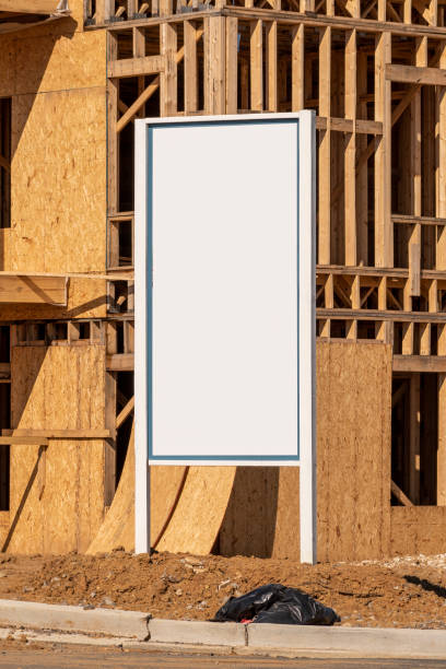 istock Blank White Sign In Front of New Apartment Construction Vertical 1369394225