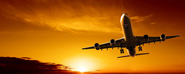 istock jet airplane landing at sunset 136939499