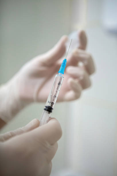 istock Infusion syringe in the hands of a nurse. Selective focus 1369395570