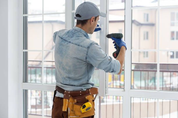 istock handyman adjusting white pvc plastic window indoors. worker using screwdriver to repair upvc window. homework maintenance. 1369396302