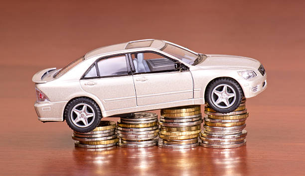 istock Model car on a pile of coins 136939655