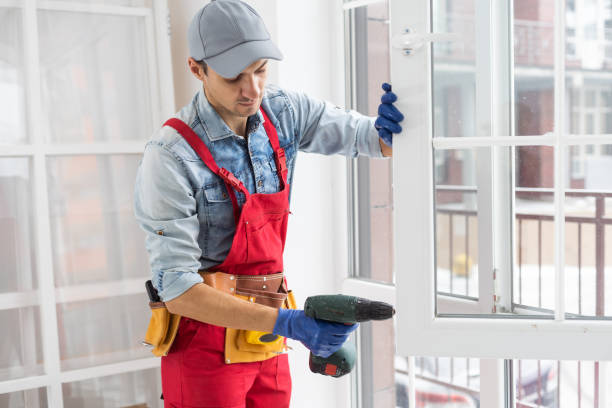 istock Construction worker installing window in house. Handyman fixing the window with screwdriver 1369397852