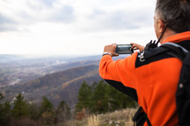 istock A senior hike snapping a photo of the scenery 1369398340