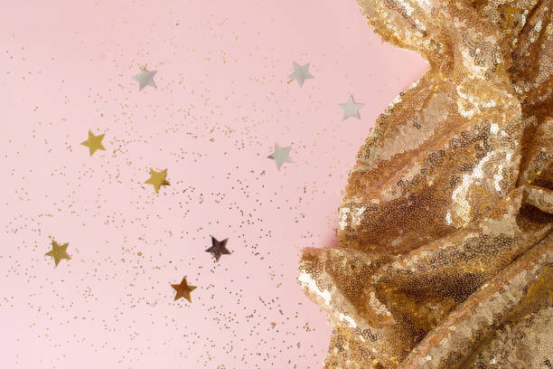 istock Golden sparkles on pink pastel trendy background. Festive backdrop for your projects. 1369398603