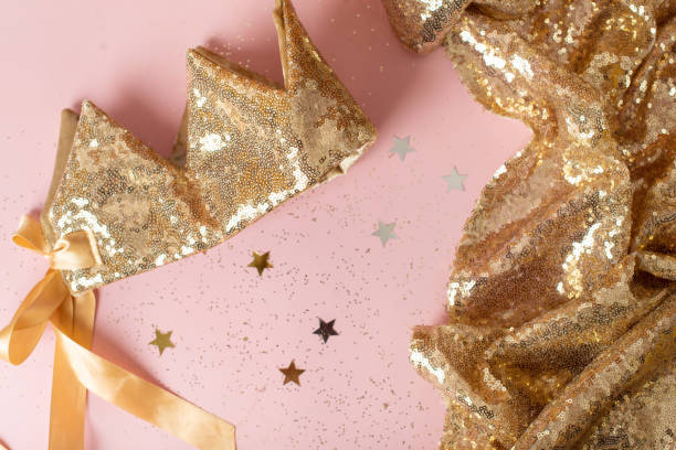 istock gold sequins and crown. flat lay with copy space 1369398606