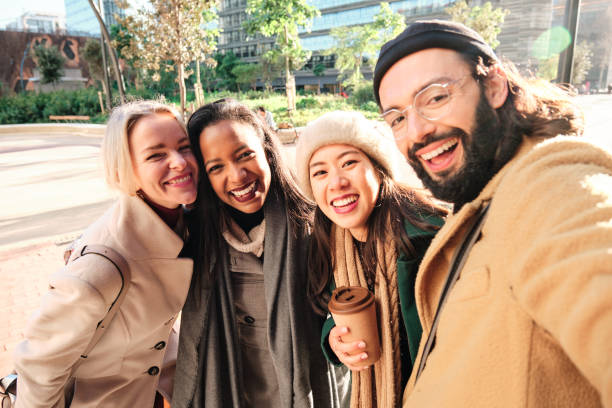 istock Group of business colleagues smiling while taking a selfie together outdoors during a break from work. 1369399354