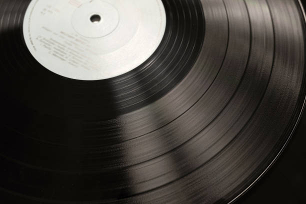istock Vinyl disc close-up. Vinyl record texture in vintage style 1369399479
