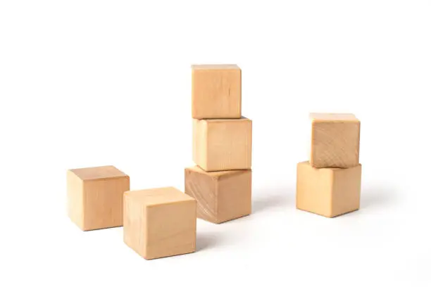 Tower of three wooden cubes, isolated on white background
