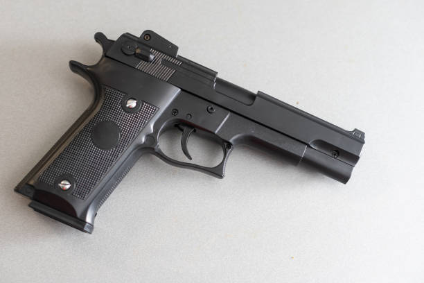istock gun on a white background. Memories and sacrifices concept 1369401237