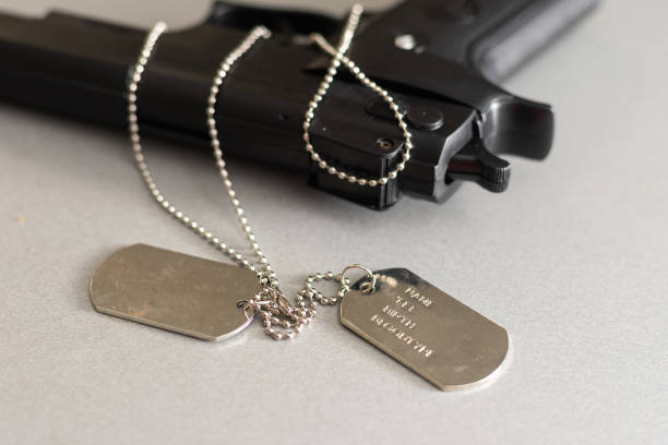 istock gun and dogtag isolated on a white background 1369401489