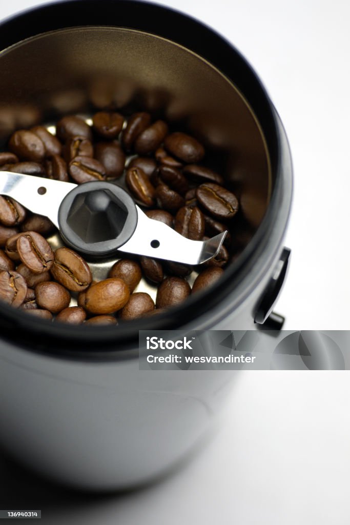 Coffee Grinder A coffee grinder with light roast beans. Appliance Stock Photo