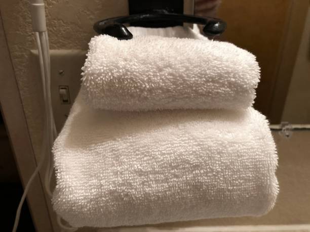 istock Folded white towels in a bathroom towel rack 1369403551