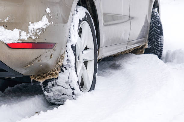 istock Car tires on winter road covered with snow 1369405572