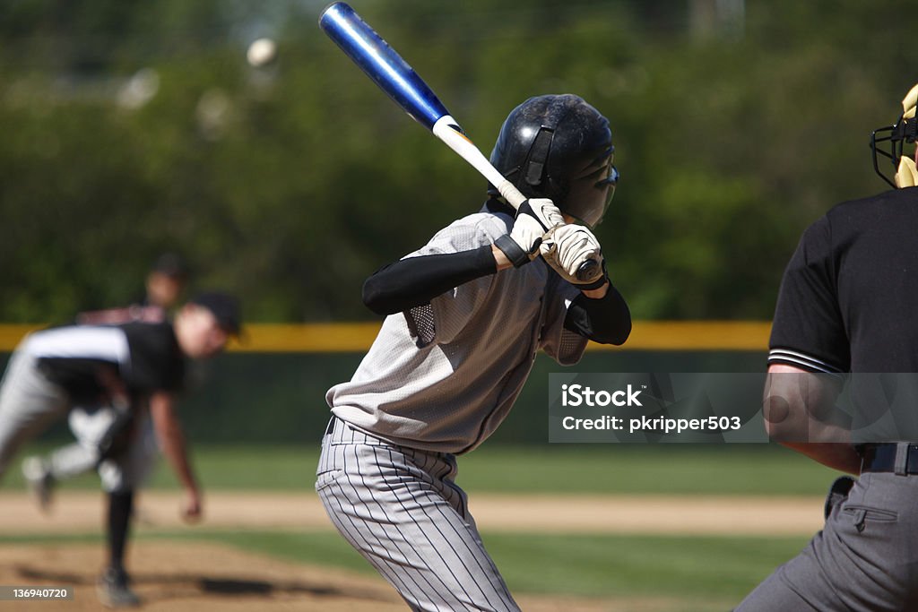 View of baseball batter from behind the catcher as they hit A batter about to hit a pitch during a baseball game. Baseball - Ball Stock Photo