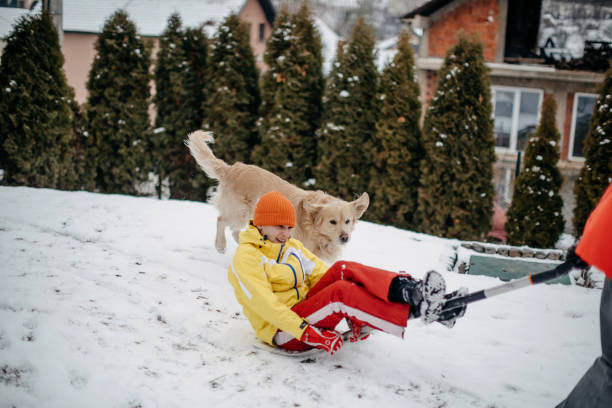 Sliding on snow while sitting on shovel