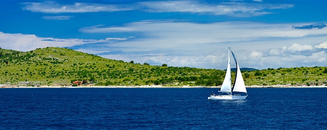 Sailboat yacht sailing in blue sea. Tourism