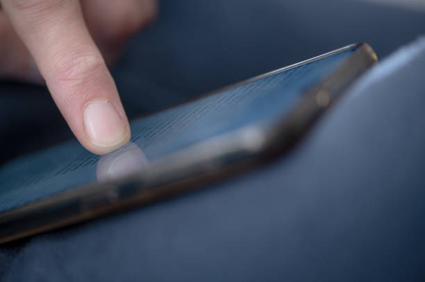 Close up shot of young woman reading from a mobile phone