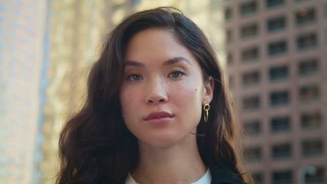 Gorgeous woman looking camera on street closeup. Portrait of asian businesswoman