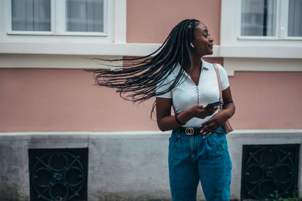 istock African american woman using smartphone while out in city 1369409625