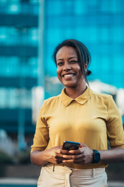 istock African american woman using a smartphone while out in the city 1369409648